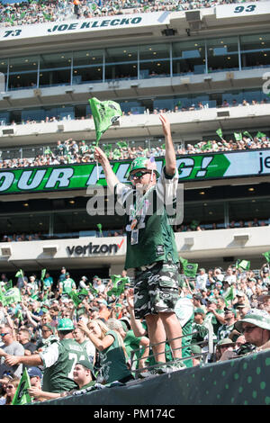 A New York Jets fan stands with a paper bag on his head in the 2nd