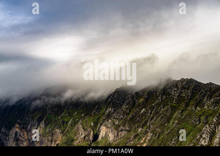Amazing view of Slieve League mountain covered in clouds and fog, from high-up on the Atlantic coast of County Donegal, Ireland Stock Photo