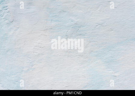 Adobe wall whitewashed by lime, white and blue color, textured background in retro style, closeup. Ukraine Stock Photo