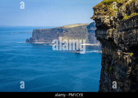 The Cliffs of Moher are sea cliffs located at the southwestern edge of the Burren region in County Clare, Ireland Stock Photo