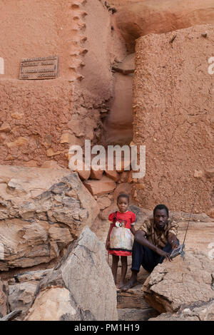 A man and a little girl in Youga Dogorou traditional Dogon village in Dogon country, Mali, Africa. Stock Photo