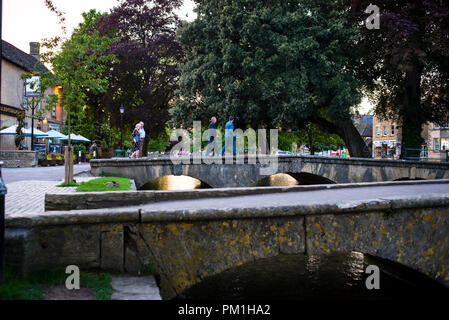 Burton-on-the-Water low stone footbridges over the River Windrush in the Cotswolds, England. Stock Photo