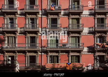 Red apartment with hanging Catalan Flag on balcony in Barcelona Stock Photo