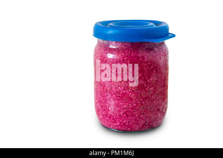 In a small glass jar grated horseradish, seasoned with beet juice. Presented on a white background. Stock Photo