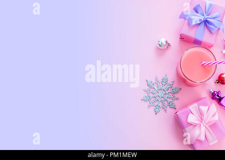 Festive background for text composition flat lay Christmas items gift box ribbon bow pink glass cocktail Christmas toys. Top view copy space Stock Photo