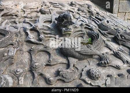 A relief dragon carved in stone Stock Photo