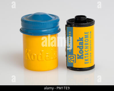 A 20 exposure roll of Kodak Ektachrome slide film and its yellow metal canister with it color coded blue screw top lid Stock Photo