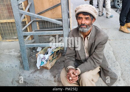 SKARDU, PAKISTAN - JULY 28 : An unidentified old man poses for a portrait as he rests after hard work July 28, 2018 in Skardu, Pakistan Stock Photo