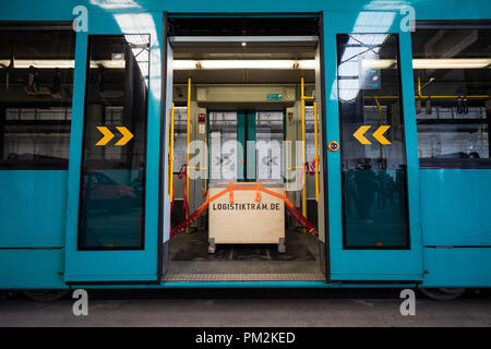 17 September 2018, Hessen, Frankfurt Main: A box used to transport goods with the inscription 'Logistiktram.de' secured with tension belts in a tram at the VGF depot Gutleut. The pilot project 'Logistiktram' is to serve the climate-friendly transport of goods. Photo: Silas Stein/dpa Stock Photo