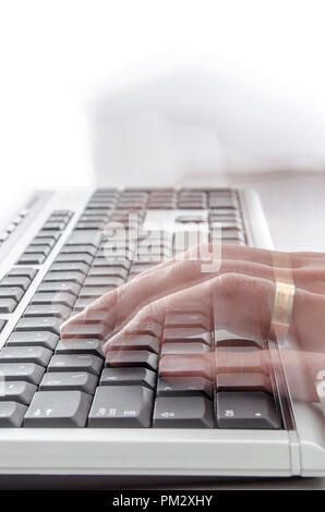Motion blurred hands typing on keyboard. Stock Photo