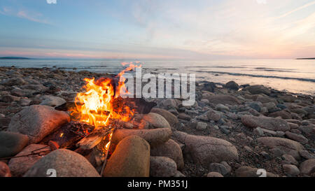 Campfire on the beach, Cheticamp, NS, Canada Stock Photo