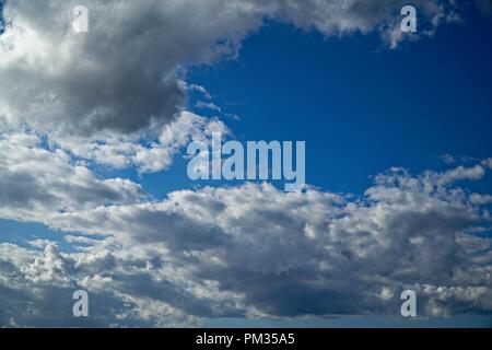 Cloud filled sky with patches of blue. Stock Photo