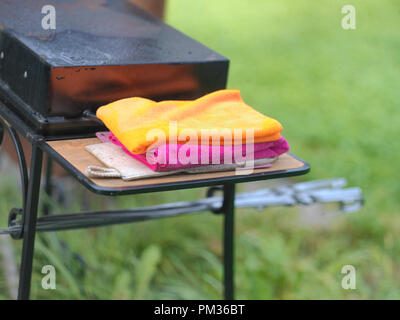 Colorful kitchen towels on a barbecue trolley, shallow depth of field Stock Photo