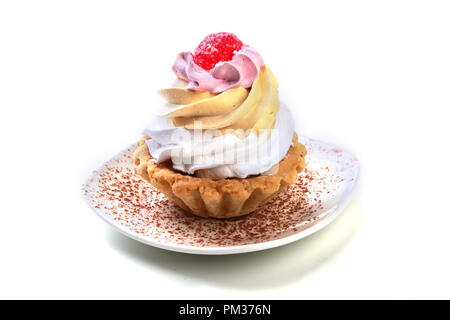 Tasty Homemade cupcake, muffin with cream and raspberry. Close up view delicious sweet dessert isolated on white. Stock Photo