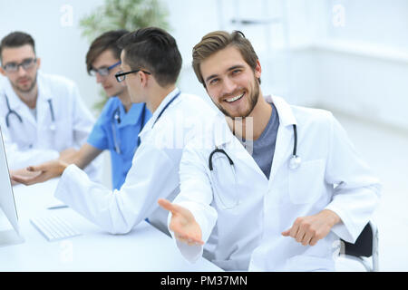 friendly doctor making a welcome gesture Stock Photo