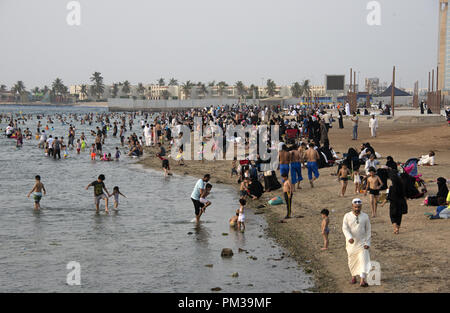 Saudi families gathered by a public Red Sea beach in Jeddah, Saudi Arabia Stock Photo