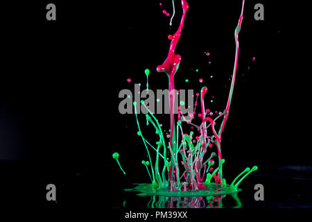 Abstract sculptures of colorful splashes of paint. Dancing liquid on a black background. Ink water splash. Color explosion. Stock Photo