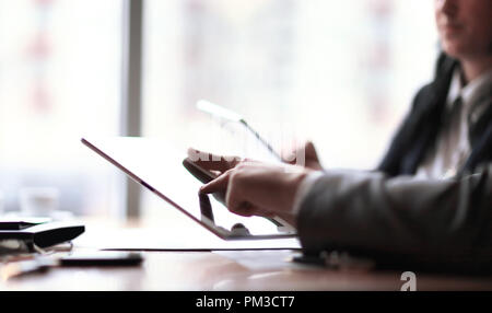 businessman clicks on the screen of a digital tablet Stock Photo