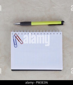 open notebook, paper clip and pen on paper background.photo with copy space Stock Photo