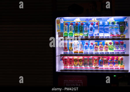 Vending machine selling Japanese beverages, soda bottles, soft drinks, mineral water and coffee cans in the streets of Tokyo, Japan, Asia. Copy space Stock Photo