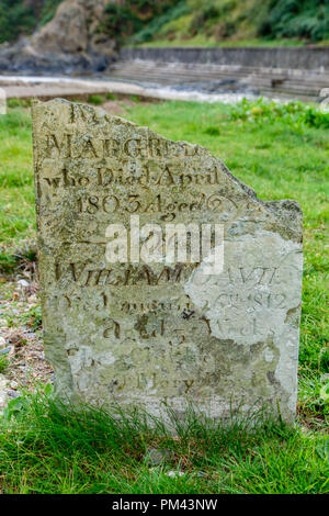 Broken gravestone at St Brynach's church at  Cwm-yr-Eglwys, near Dinas Cross, Fishguard, Pemrbrokeshire Stock Photo