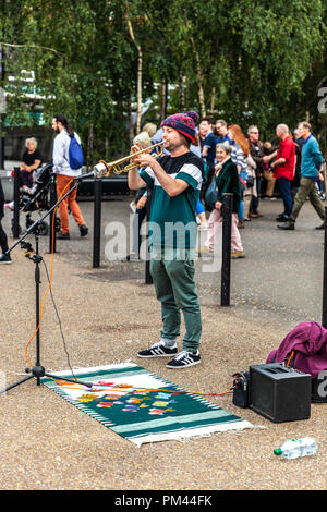 A busker playing the trumpet, London, England, UK. Stock Photo