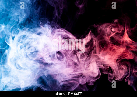 Dense multicolored smoke of  pink,  blue and red colors on a black isolated background. Background of smoke vape Stock Photo