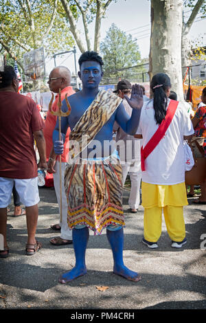 Posed portrait of a Hindu young man in blue dressed as the God Shiva at the conclusion of the Madrassi Parade in Richmond Hill, Queens, New York. Stock Photo