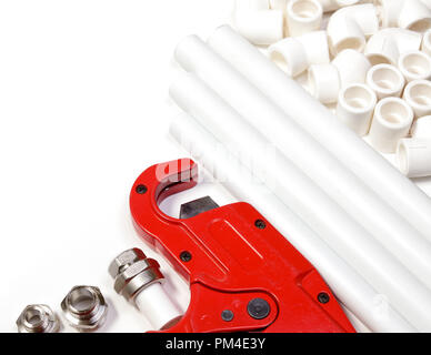 Polypropylene pipes  fittings and cutter on white background Stock Photo