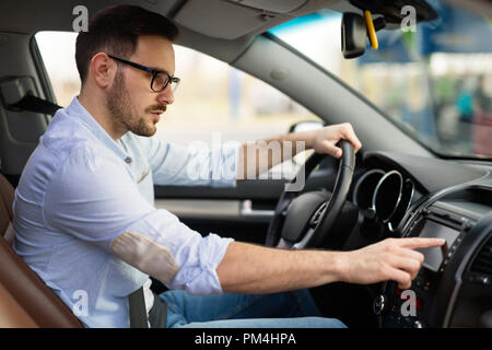 Man using navigation system while driving car Stock Photo
