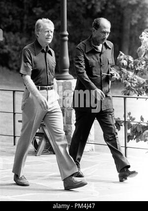 United States President Jimmy Carter, left and President Anwar Sadat of Egypt, right, walk behind Aspen Lodge at Camp David, near Thurmont, Maryland prior to their meeting on Tuesday, September 12, 1978. Photo by White House   File Reference # 1003 508THA Stock Photo
