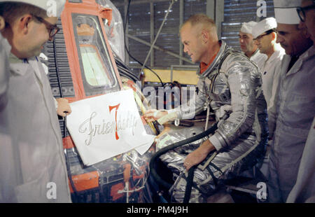 Astronaut John Glenn inspects artwork that will be painted on the outside of his Mercury spacecraft, which he nicknamed Friendship 7. On Feb. 20, 1962, Glenn lifted off into space aboard his Mercury Atlas (MA-6) rocket to become the first American to orbit the Earth. After orbiting the Earth 3 times, Friendship 7 landed in the Atlantic Ocean, just East of Grand Turk Island in the Bahamas. Glenn and his capsule were recovered by the Navy Destroyer Noa, 21 minutes after splashdown  File Reference # 1003 623THA Stock Photo