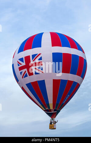Red white and blue Union Jack hot air balloon in the sky at Longleat Sky Safari, Wiltshire, UK in September Stock Photo
