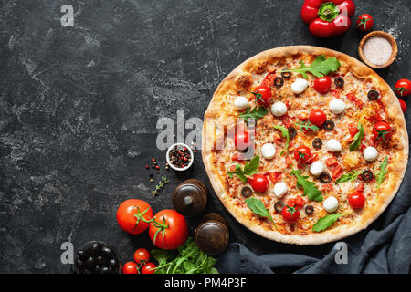 Italian Pizza On Black Concrete Background. Copy Space For Text. Tasty Pizza Stock Photo