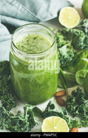Green smoothie in a glass bottle. Kale Lime Spinach Green Apple Detox Smoothie Stock Photo