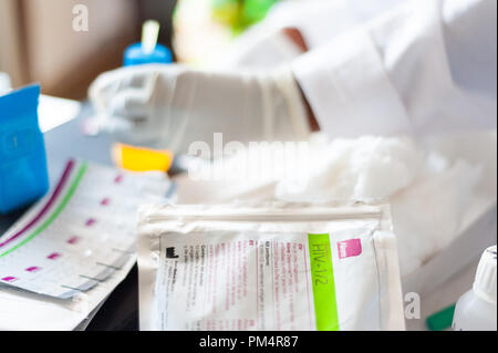 detail of free hiv test in african hospital with doctor hand in background Stock Photo