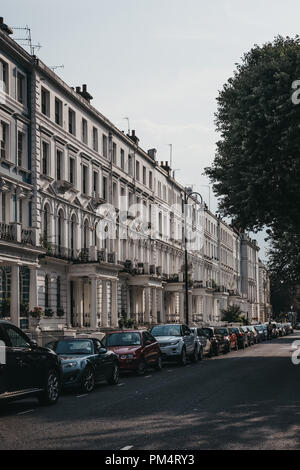 London, UK - July 21, 2018: Cars parked alongside terraced houses in Notting Hill, London, one of the most luxurious areas of the city famous for the  Stock Photo