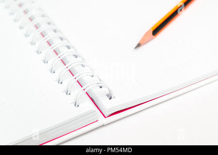 white background, notepad for notes, blank on rings, simple pencil Stock Photo
