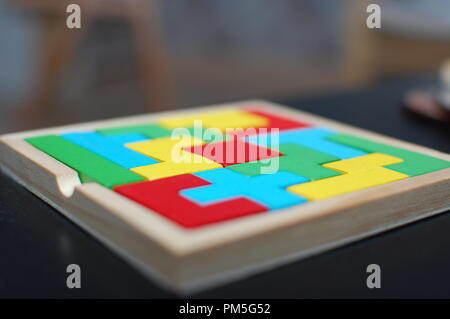 Colourful puzzle on black table makes great background. Stock Photo