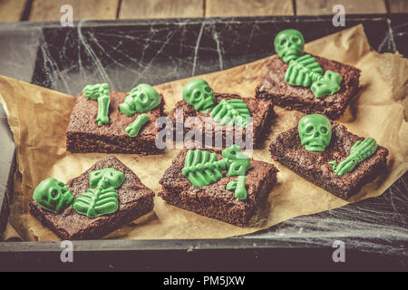 Halloween style party sweet - brownie with green skeleton and bones Stock Photo