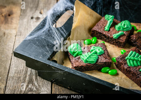 Halloween style party sweet - brownie with green skeleton and bones Stock Photo