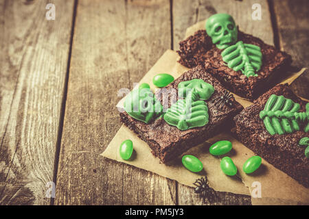 Halloween style party sweet - brownie with green skeleton and bones Stock Photo