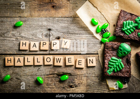 Halloween style party sweet - brownie with green skeleton and bones Stock Photo