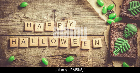 Halloween style party sweet - brownie with green skeleton and bones Stock Photo