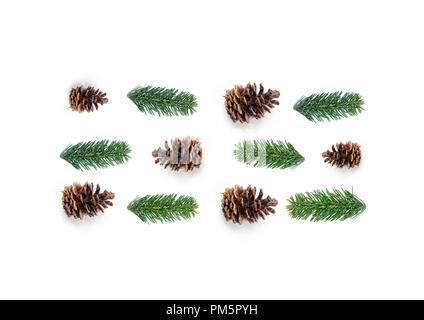 Natural Christmas layout composition, top view with fir tree branches and pine cones in rows. Stock Photo