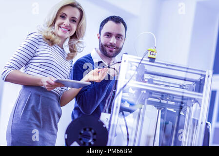 Joyful young engineers working together with pleasure Stock Photo