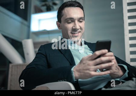 Handsome nice man holding a mobile phone Stock Photo