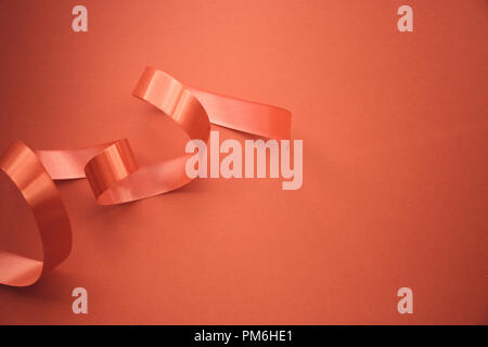 red ribbon on red background with copy space. Stock Photo
