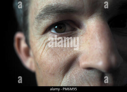 Portrait of man on black background, close up on eye Stock Photo