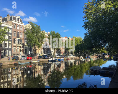 Canal and buildings in Amsterdam, Netherlands on a sunny summer afternoon